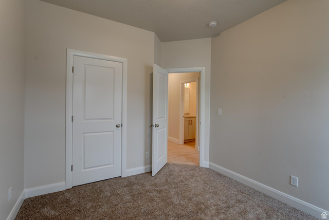 1512 West 600 North, Unit O4A Mapleton, UT 84664 - Photo 20 of 24 Unfurnished bedroom featuring baseboards and light carpet