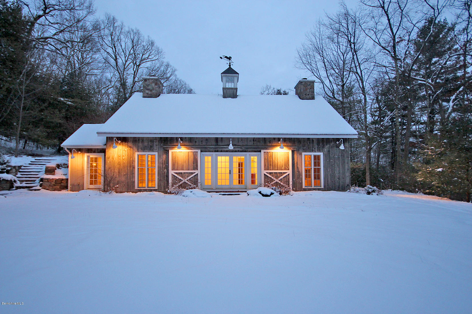 a front view of a house with swing and plants