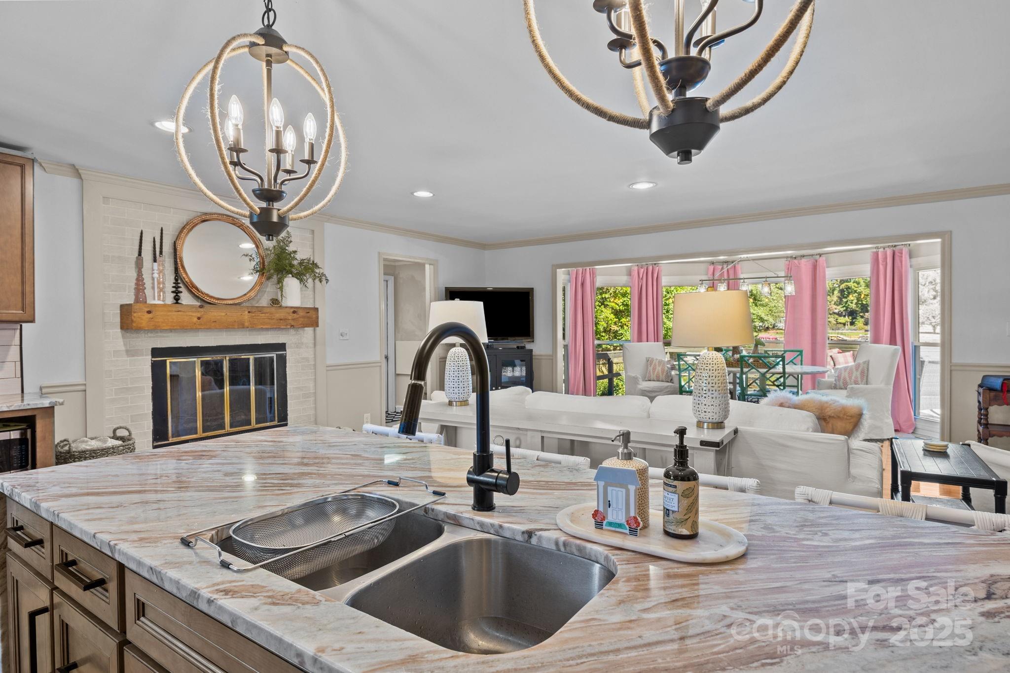 255 Topsail Road Salisbury, NC 28146 - Photo 21 of 47 a kitchen with a table chairs a chimney and a chandelier