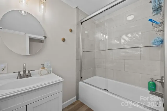 a bathroom with a sink a mirror and a bathtub