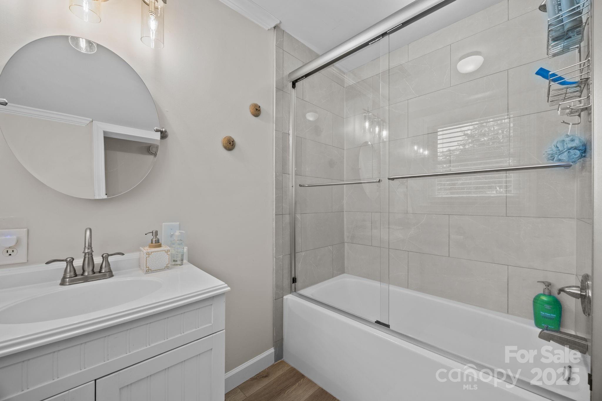 255 Topsail Road Salisbury, NC 28146 - Photo 26 of 47 a bathroom with a sink a mirror and a bathtub