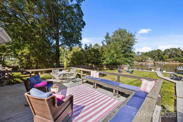 a view of deck with chairs and wooden floor