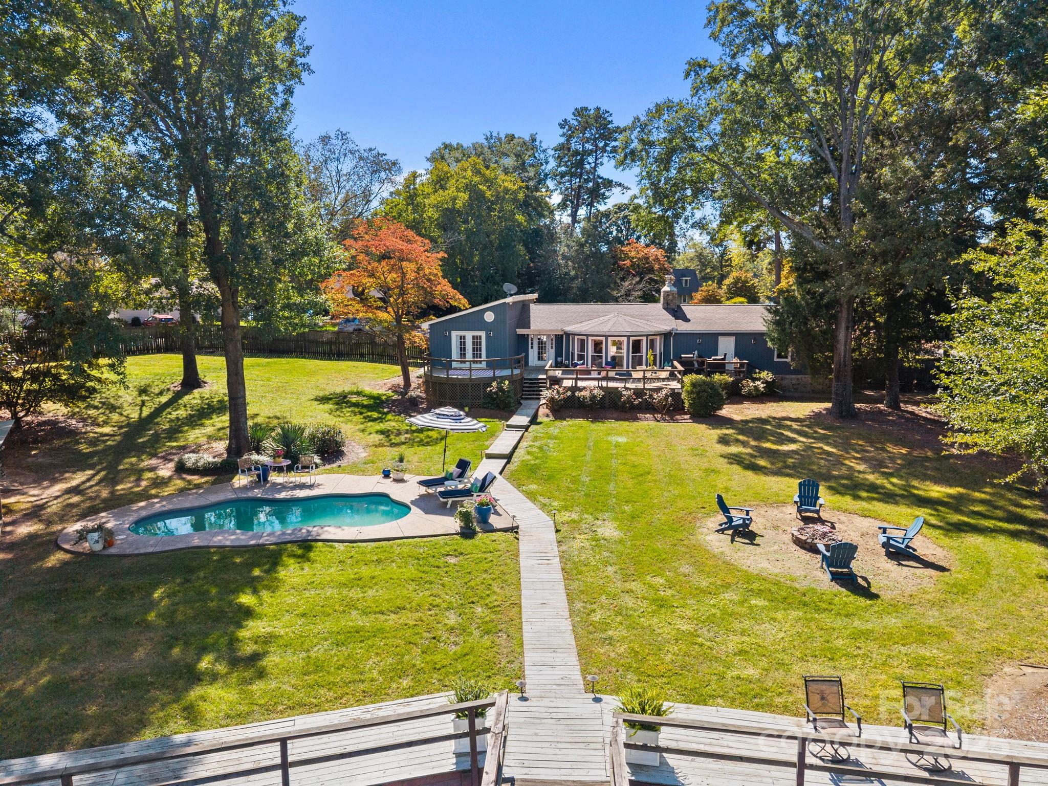 255 Topsail Road Salisbury, NC 28146 - Photo 44 of 47 a view of a swimming pool with an outdoor seating and a yard