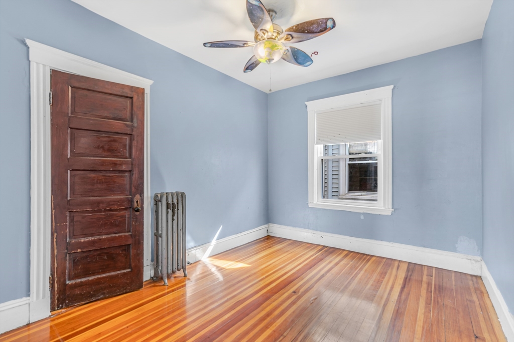 36 Mt Ida Road, Unit 3 Boston, MA 02122 - Photo 13 of 20 a view of empty room with wooden floor and fan