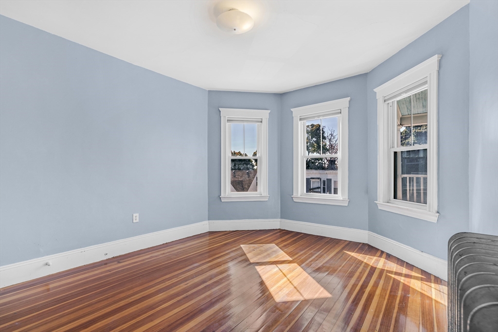 36 Mt Ida Road, Unit 3 Boston, MA 02122 - Photo 15 of 20 a view of empty room with wooden floor and fan