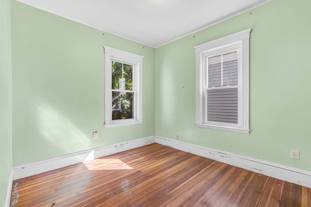 36 Mt Ida Road, Unit 3 Boston, MA 02122 - Photo 16 of 20 an empty room with wooden floor and windows