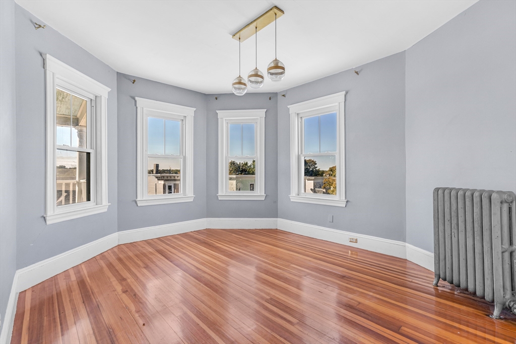 36 Mt Ida Road, Unit 3 Boston, MA 02122 - Photo 5 of 20 a bedroom with bed and window