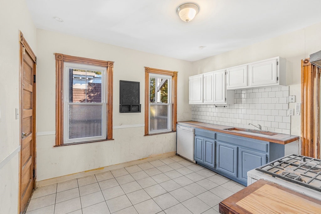 36 Mt Ida Road, Unit 3 Boston, MA 02122 - Photo 8 of 20 a large kitchen with granite countertop a sink and cabinets