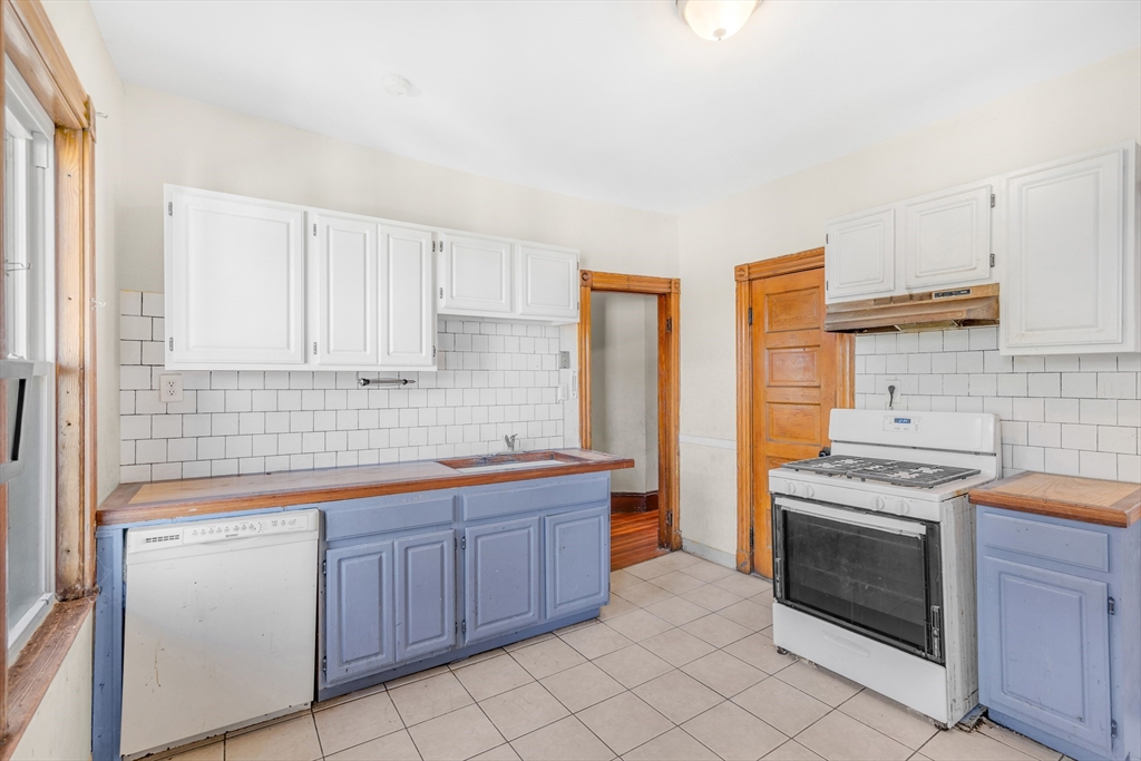 36 Mt Ida Road, Unit 3 Boston, MA 02122 - Photo 10 of 20 a kitchen with stainless steel appliances granite countertop a stove a sink and a refrigerator