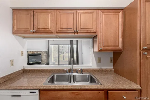 a kitchen with granite countertop a sink and cabinets