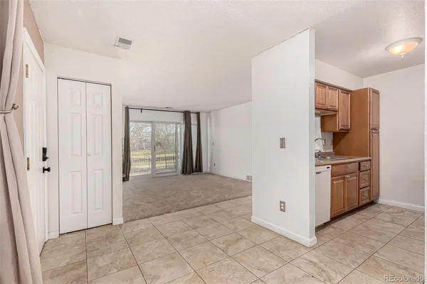 a kitchen with stainless steel appliances a refrigerator and a stove top oven