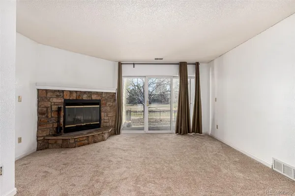 an empty room with furniture and a fireplace