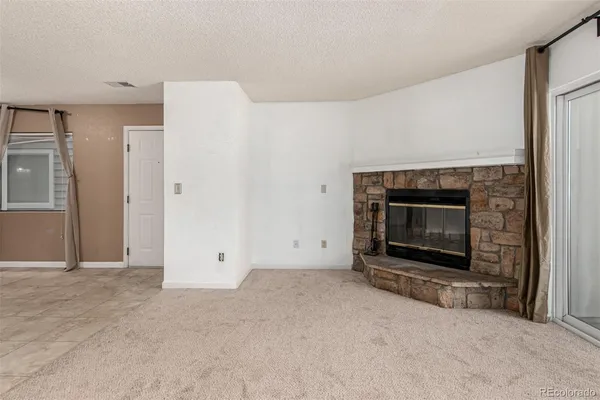 a view of empty room with a fireplace