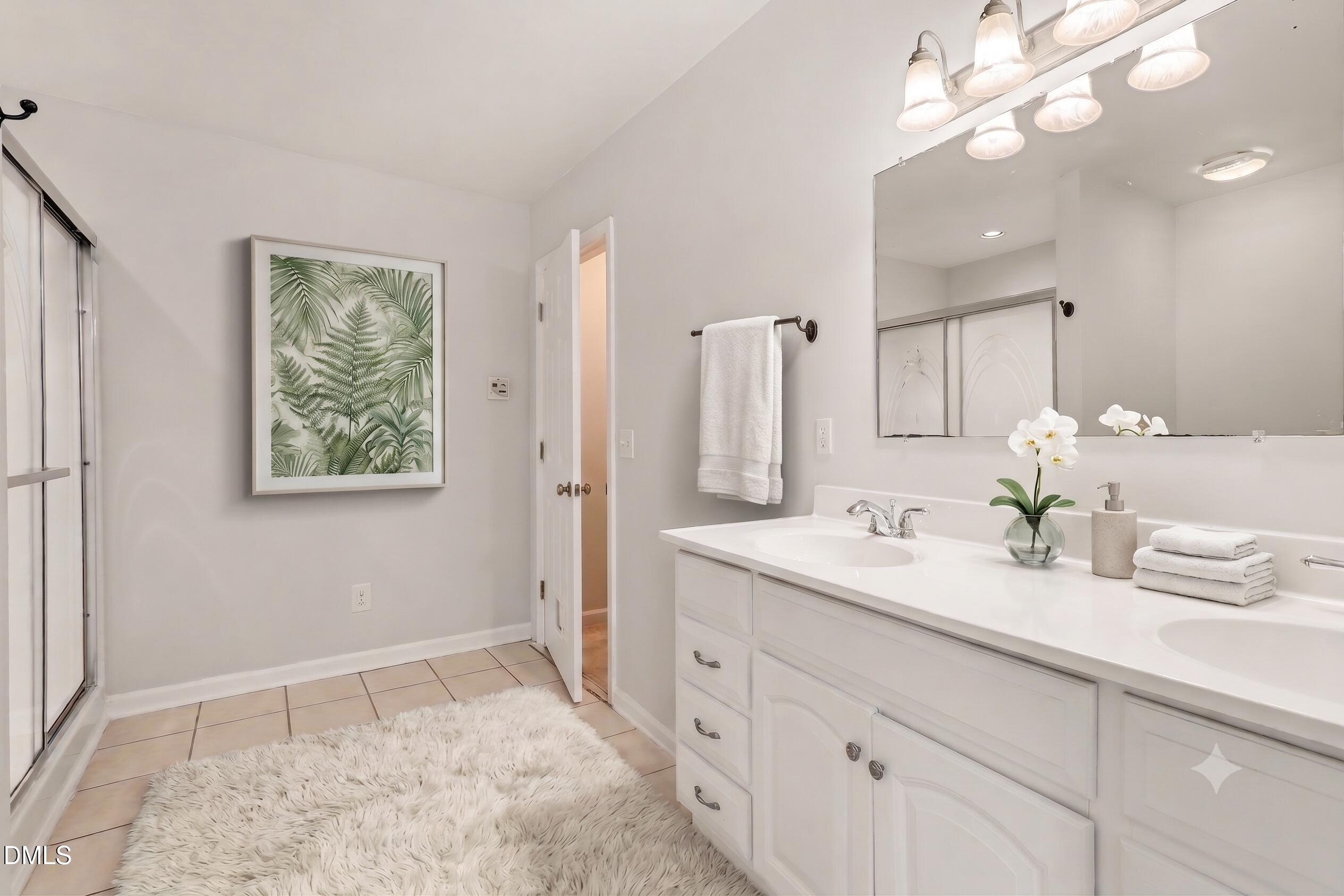 1782 Chicora Road Dunn, NC 28334 - Photo 29 of 72 a bathroom with a sink a vanity and a large mirror