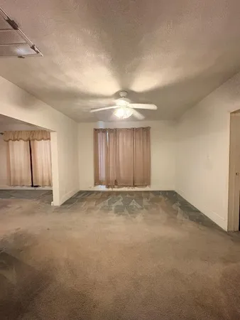 an empty room with a empty space and windows