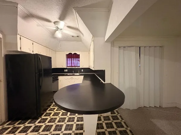 a room with a black white checkered floor and a chandelier