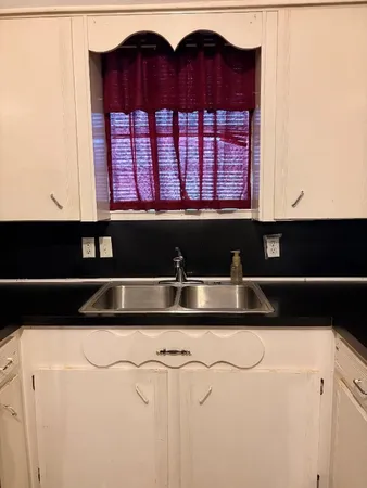 a kitchen with a sink and a large window