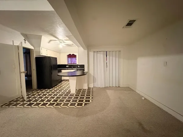 a kitchen with stainless steel appliances kitchen island granite countertop a refrigerator and a sink