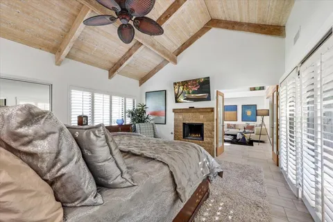 a large bedroom with a large bed and a fireplace