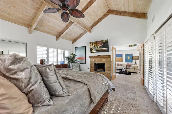 a large bedroom with a large bed and a fireplace
