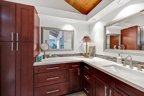 a bathroom with a double vanity sink and a mirror
