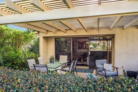a view of a patio with table and chairs and potted plants