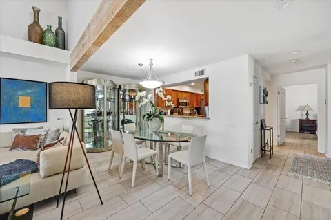 a view of a livingroom with furniture and a floor to ceiling window