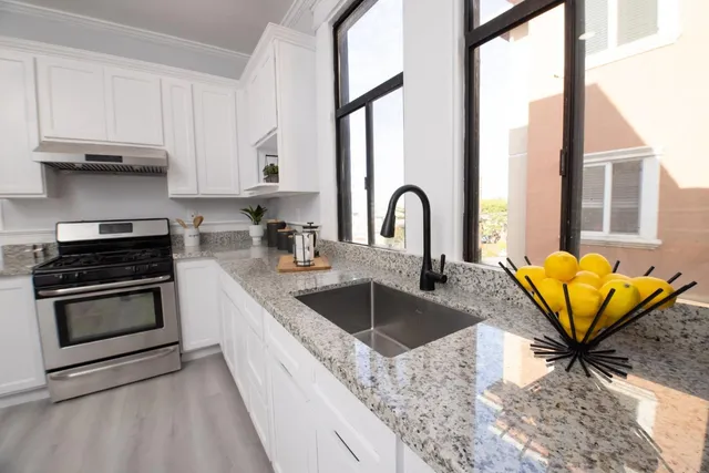 a kitchen with stainless steel appliances granite countertop a sink and a granite counter tops