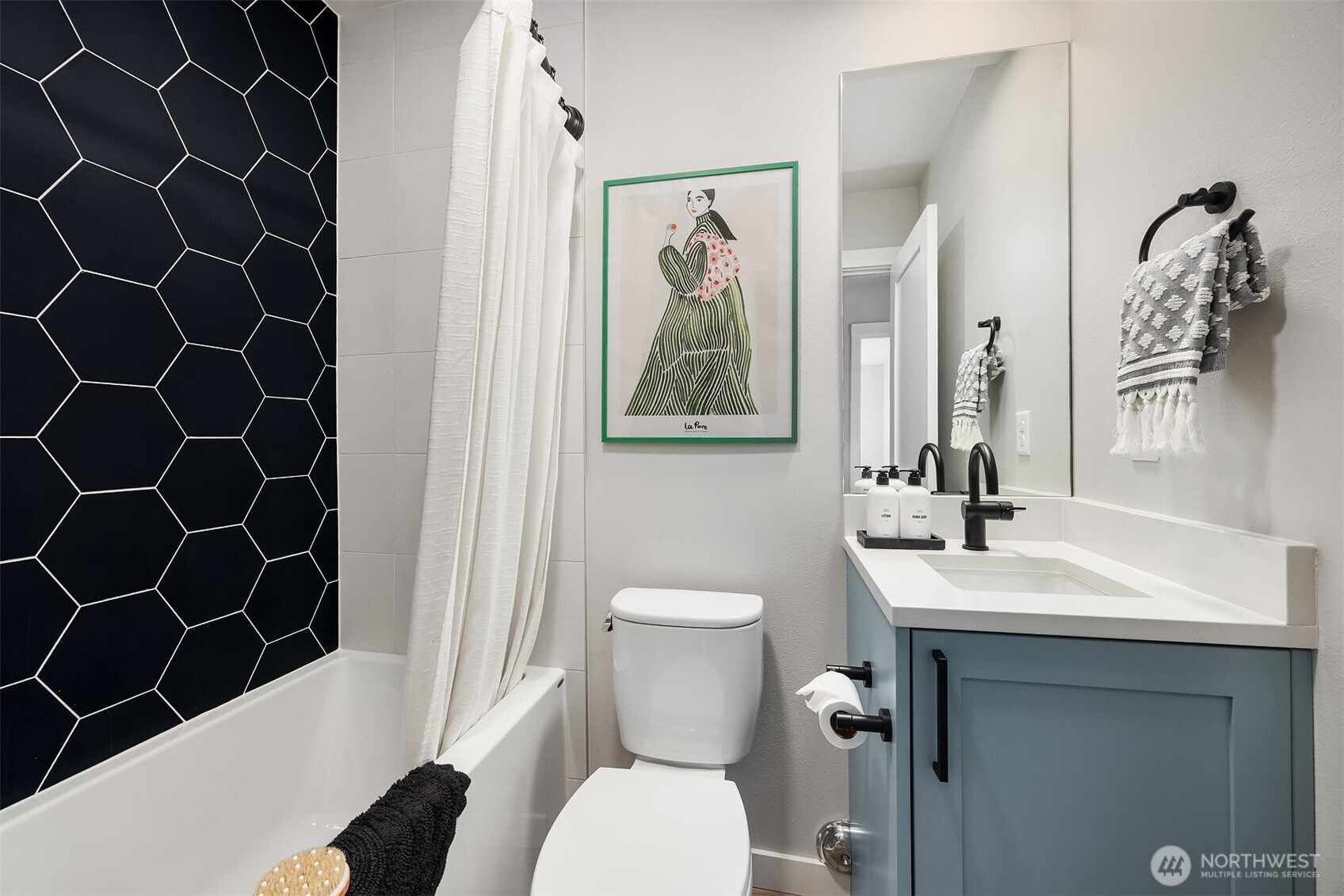516 North 61st Street, Unit B Seattle, WA 98103 - Photo 14 of 17 a bathroom with a toilet a sink and a mirror