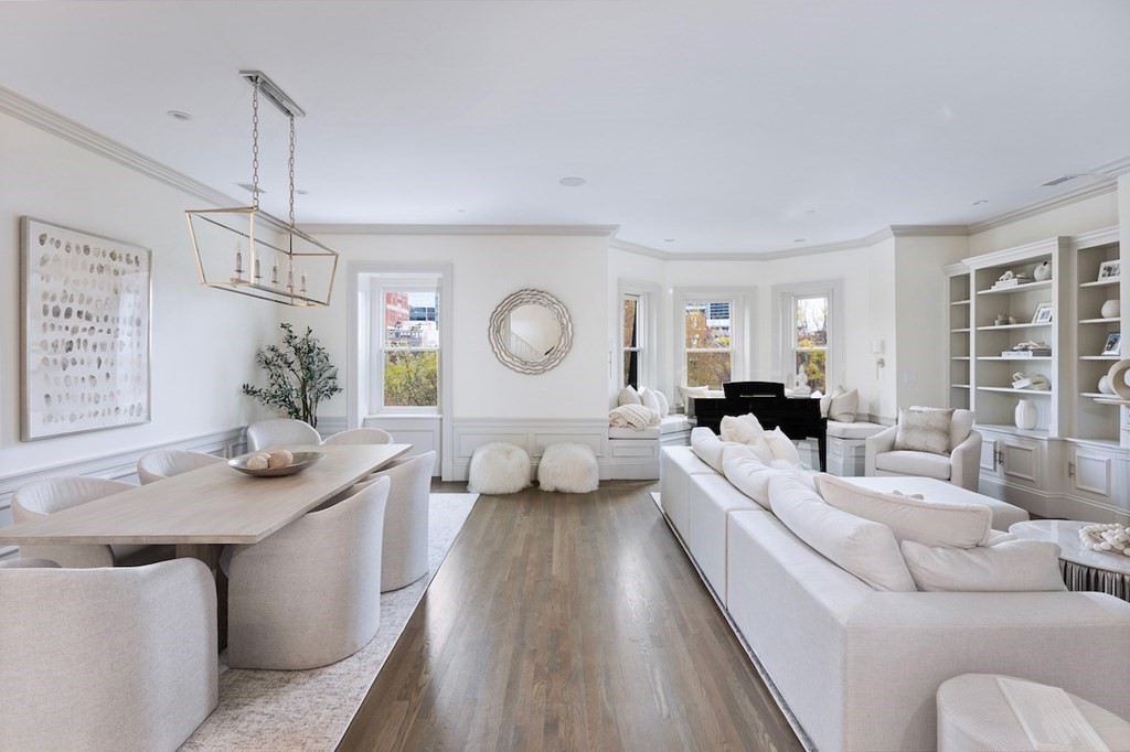 a living room with furniture chandelier and a view of kitchen