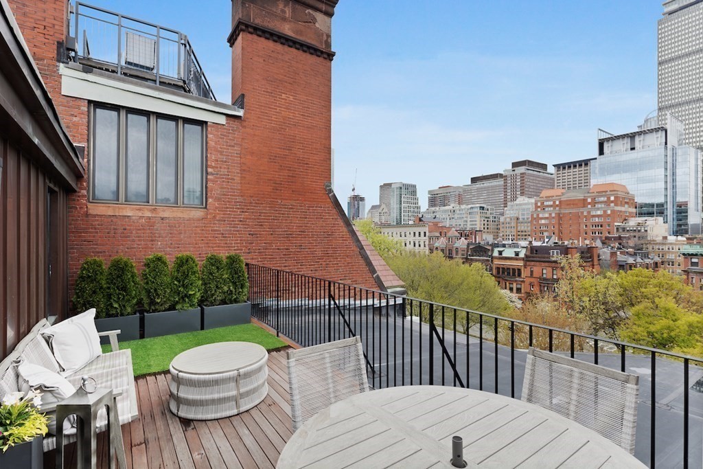 283 Commonwealth Avenue, Unit PH Boston, MA 02115 - Photo 11 of 18 a view of a roof deck with couches table and chairs
