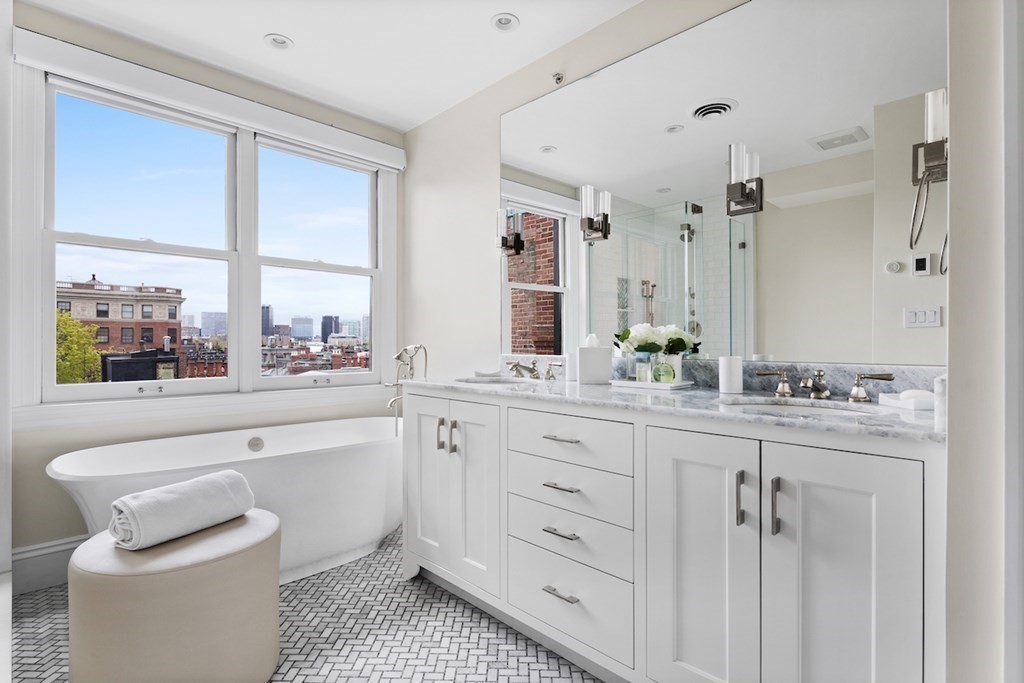 283 Commonwealth Avenue, Unit PH Boston, MA 02115 - Photo 12 of 18 a spacious bathroom with a granite countertop sink a toilet and a window