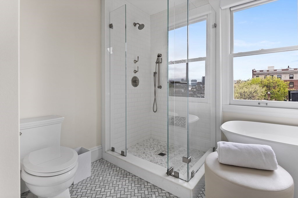 283 Commonwealth Avenue, Unit PH Boston, MA 02115 - Photo 13 of 18 a bathroom with a shower a toilet and a sink