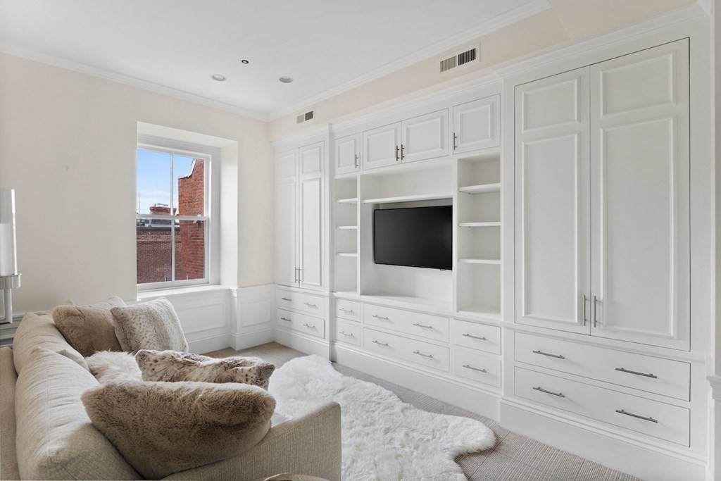 283 Commonwealth Avenue, Unit PH Boston, MA 02115 - Photo 14 of 18 a living room with furniture and a flat screen tv