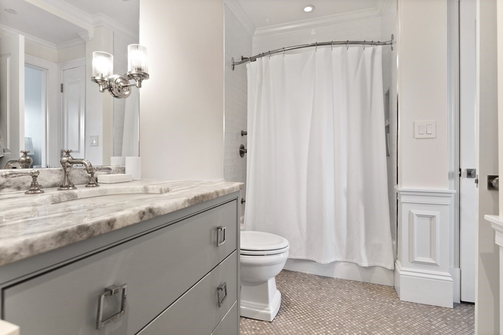 283 Commonwealth Avenue, Unit PH Boston, MA 02115 - Photo 16 of 18 a bathroom with a granite countertop sink a toilet and a mirror