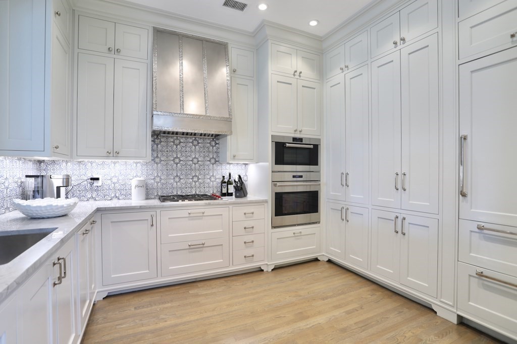 283 Commonwealth Avenue, Unit PH Boston, MA 02115 - Photo 5 of 18 a kitchen with granite countertop white cabinets and white appliances
