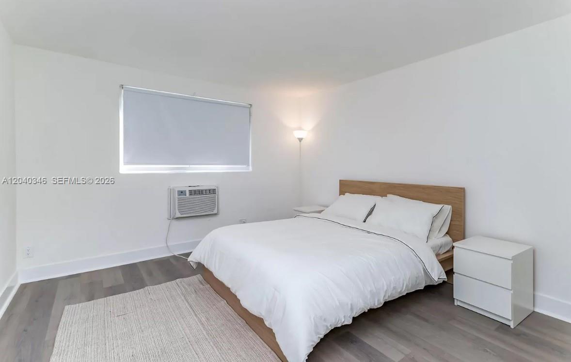 143 Southwest 9th Street, Unit 301 Miami, FL 33130 - Photo 8 of 16 a bedroom with a bed and a couch