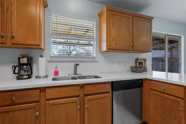 a kitchen with stainless steel appliances granite countertop wooden cabinets a sink and dishwasher
