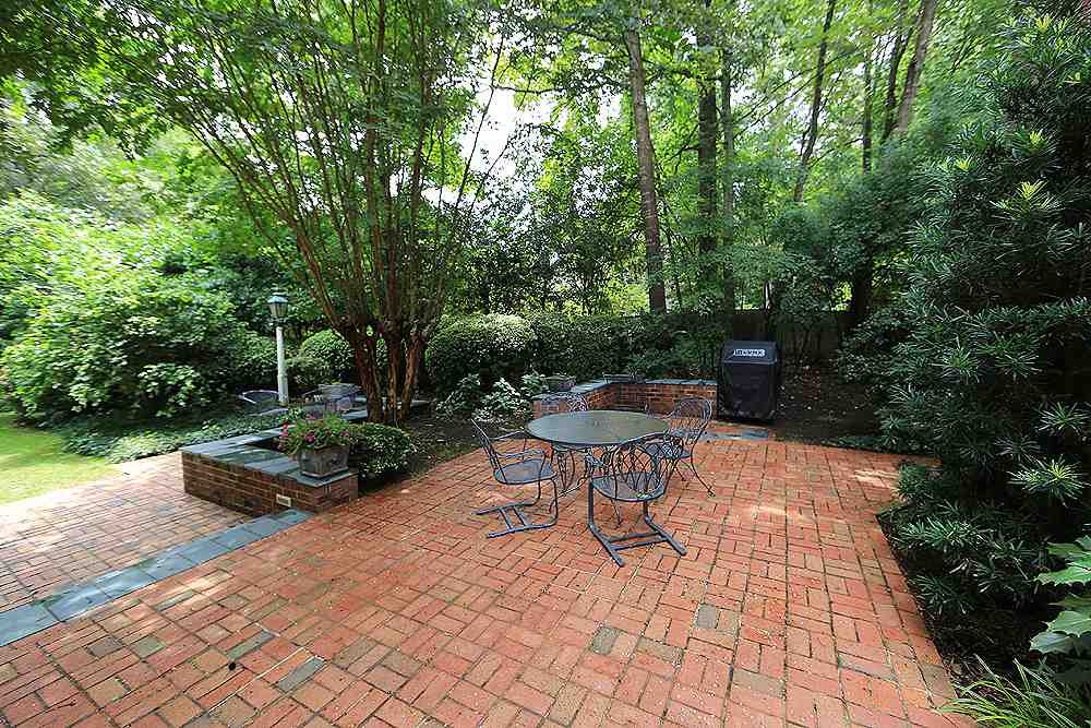 2512 10th Avenue Raleigh, NC 27612 - Photo 21 of 24 a backyard of a house with fountain table and chairs