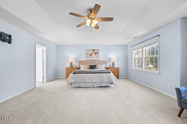 a spacious bedroom with a bed and window