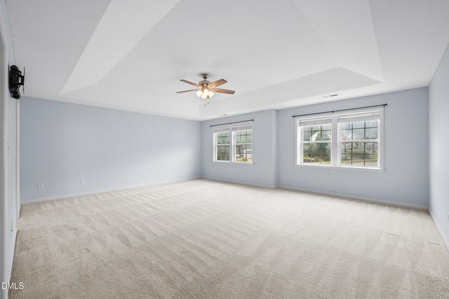 a view of an empty room with windows