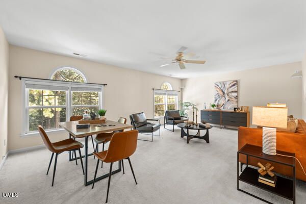 a living room with furniture a table and a large window