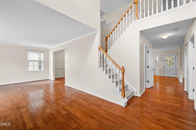 a view of an entryway with wooden floor and stairs