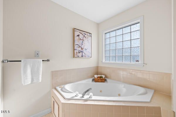 a bathroom with a tub and a window