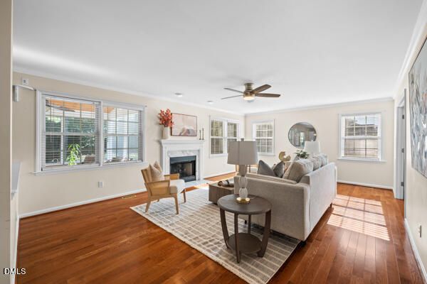 a living room with fireplace furniture and a large window