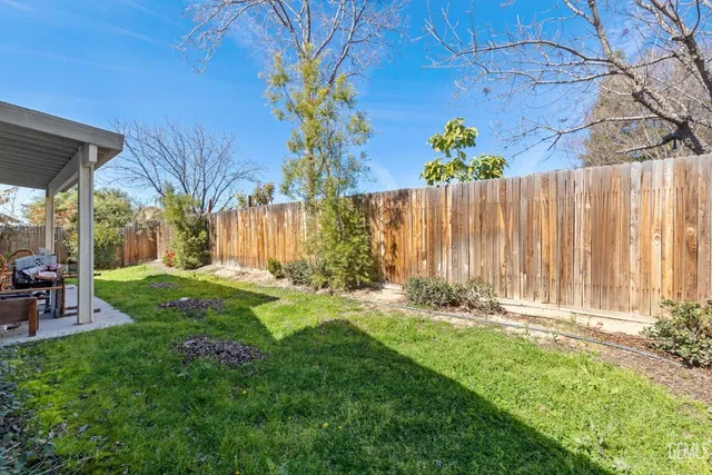 a backyard of a house with table and chairs