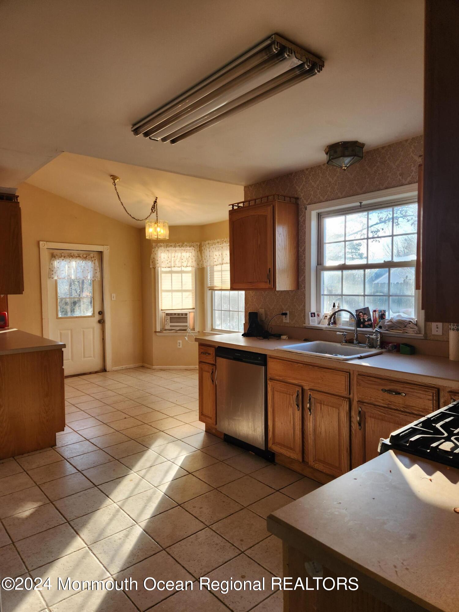 133 Brigantine Road Manahawkin, NJ 08050 - Photo 7 of 11 a kitchen with stainless steel appliances granite countertop a sink and cabinets