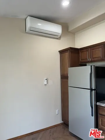 a white refrigerator freezer and a stove sitting inside of a kitchen