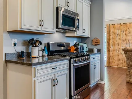 a kitchen with stainless steel appliances a refrigerator sink and cabinets