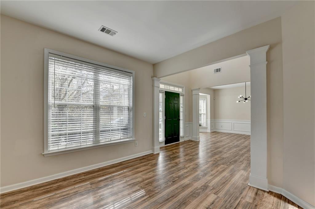 100 Hawnley Trc Northwest Suwanee, GA 30024 - Photo 12 of 58 a view of an empty room with wooden floor and a window